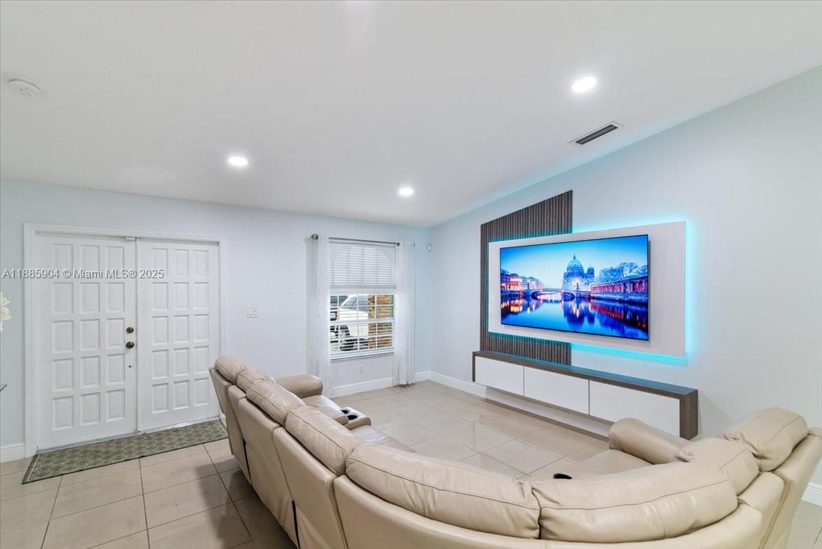 14500 Southwest 173rd Street Miami, FL 33177 - Photo 7 of 47 a living room with furniture and a wall painting