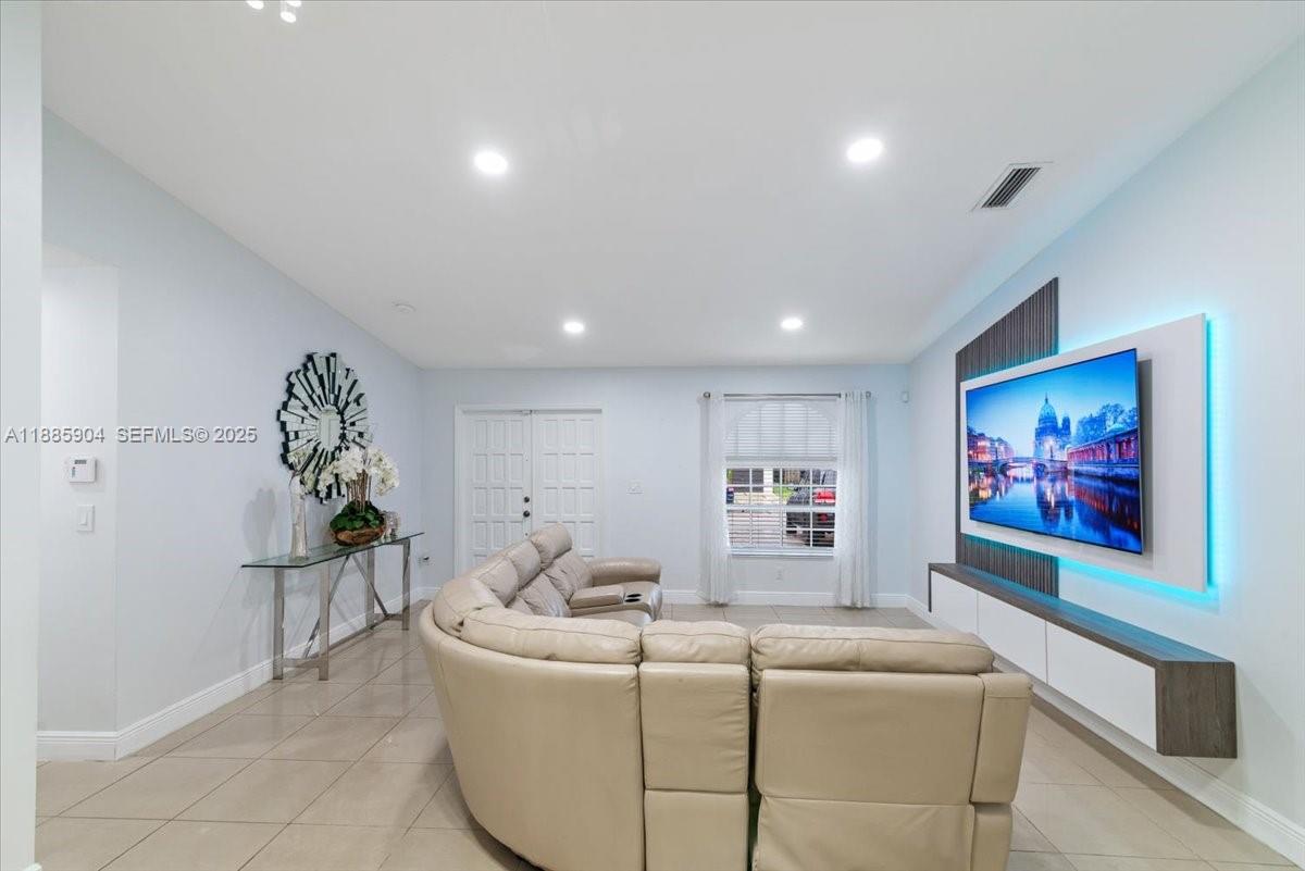 14500 Southwest 173rd Street Miami, FL 33177 - Photo 9 of 47 a living room with furniture and wall paintings