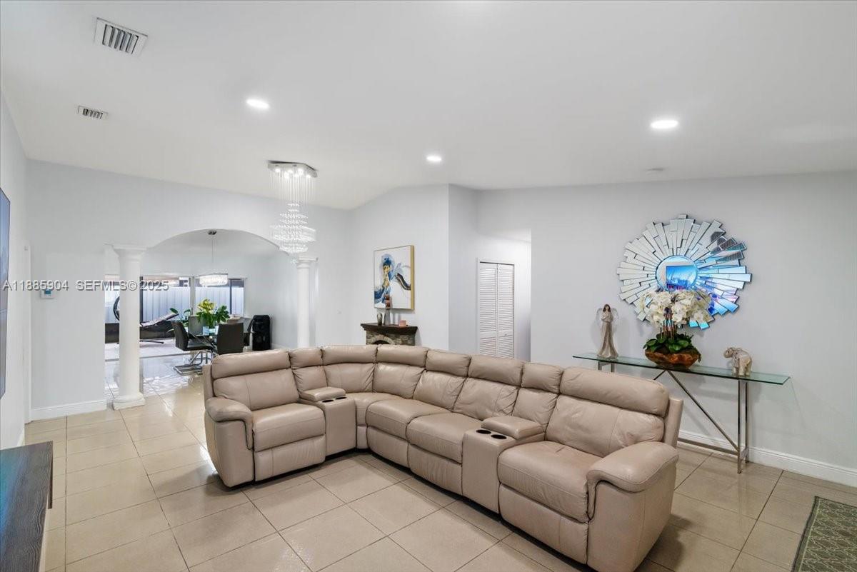 14500 Southwest 173rd Street Miami, FL 33177 - Photo 10 of 47 a living room with furniture and a chandelier