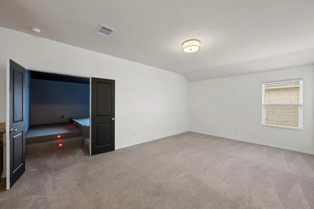 a view of an empty room with a kitchen