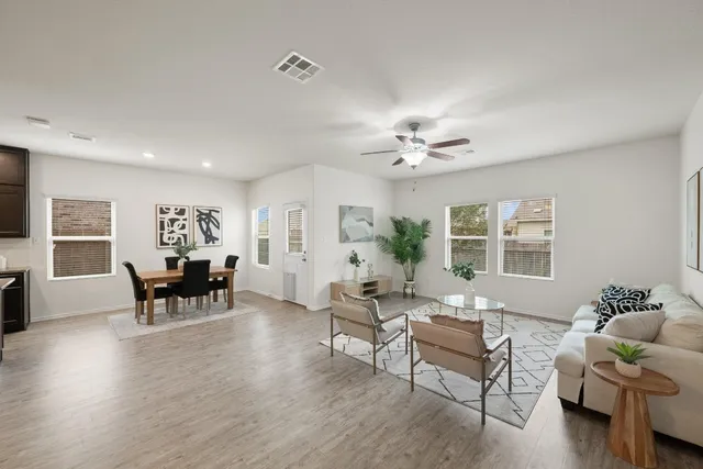 a living room with furniture and wooden floor