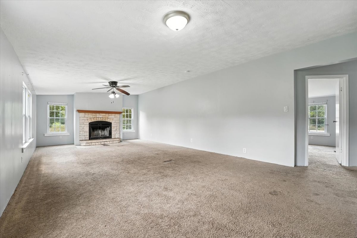 9484 Rocky Hill Road Lascassas, TN 37085 - Photo 12 of 38 an empty room with fireplace and window