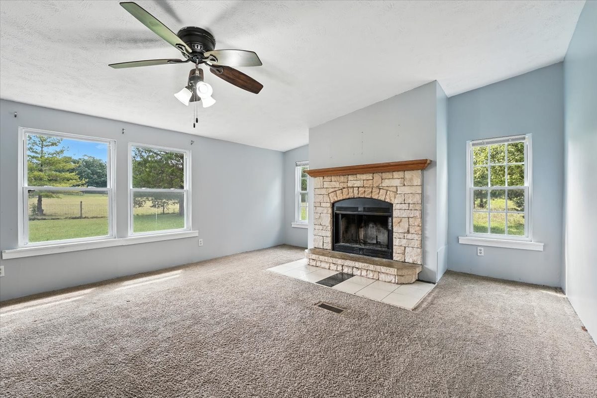 9484 Rocky Hill Road Lascassas, TN 37085 - Photo 14 of 38 a view of an empty room with a fireplace and a window