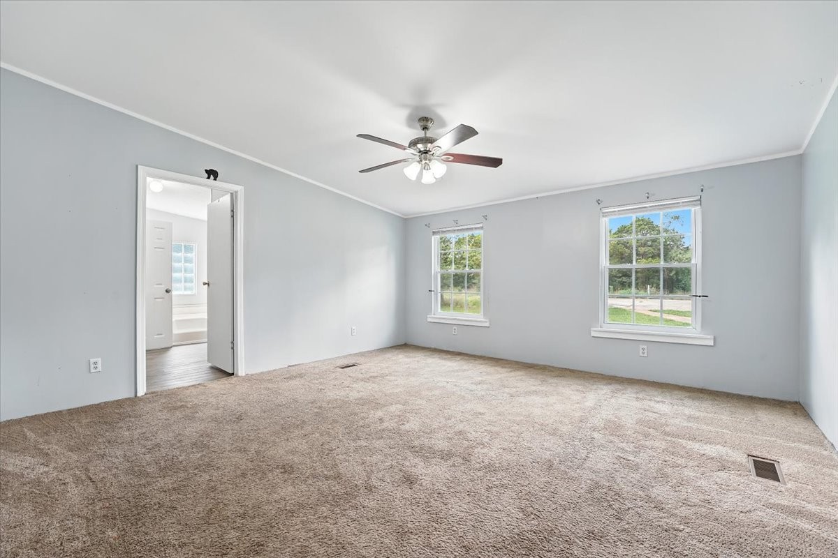 9484 Rocky Hill Road Lascassas, TN 37085 - Photo 16 of 38 an empty room with windows and ceiling fan