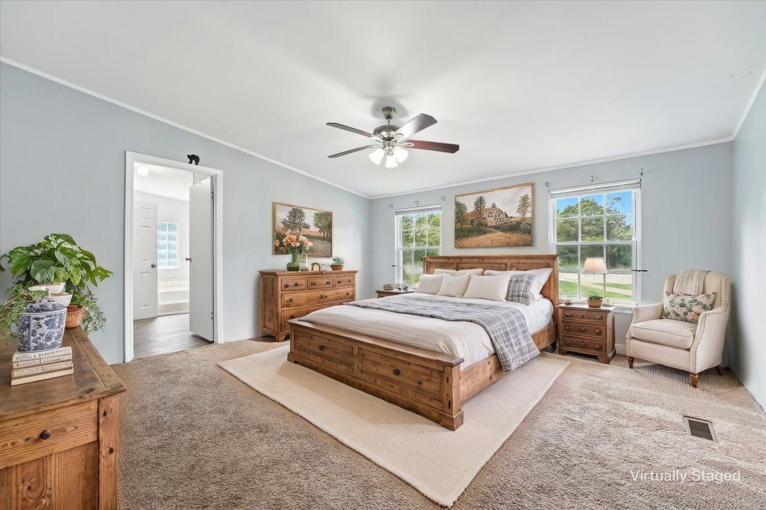 9484 Rocky Hill Road Lascassas, TN 37085 - Photo 17 of 38 a spacious bedroom with a bed a couch and potted plant