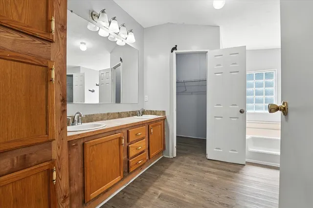 a bathroom with a double vanity sink mirror and shower