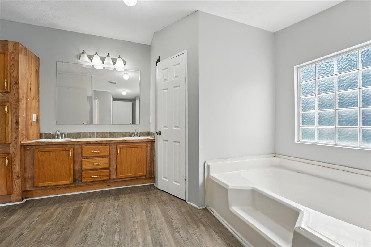 9484 Rocky Hill Road Lascassas, TN 37085 - Photo 22 of 38 a spacious bathroom with a granite countertop sink mirror and a bathtub