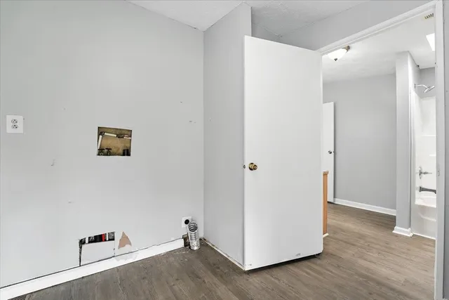 an empty room with wooden floor and white doors