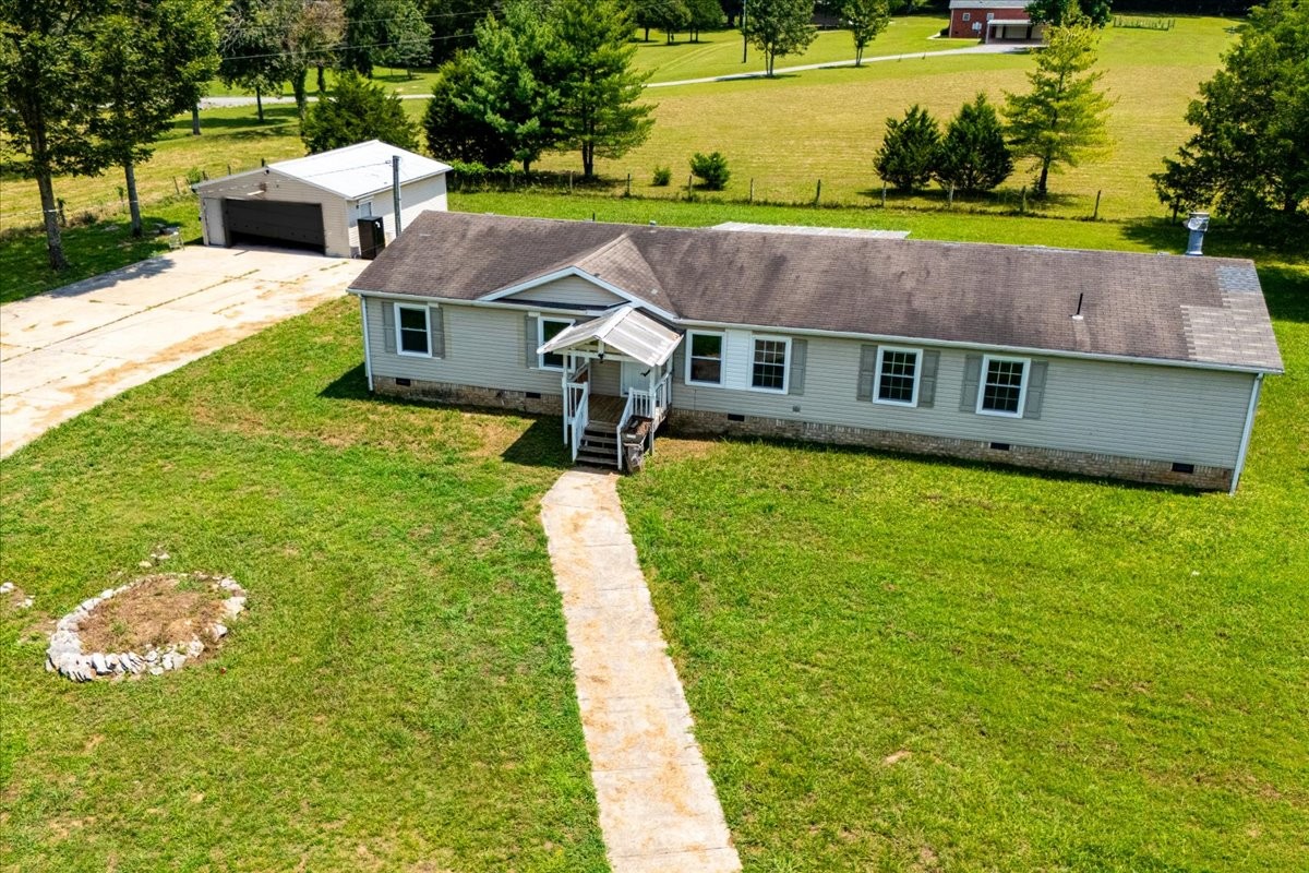 9484 Rocky Hill Road Lascassas, TN 37085 - Photo 3 of 38 a aerial view of a house with a yard table and chairs