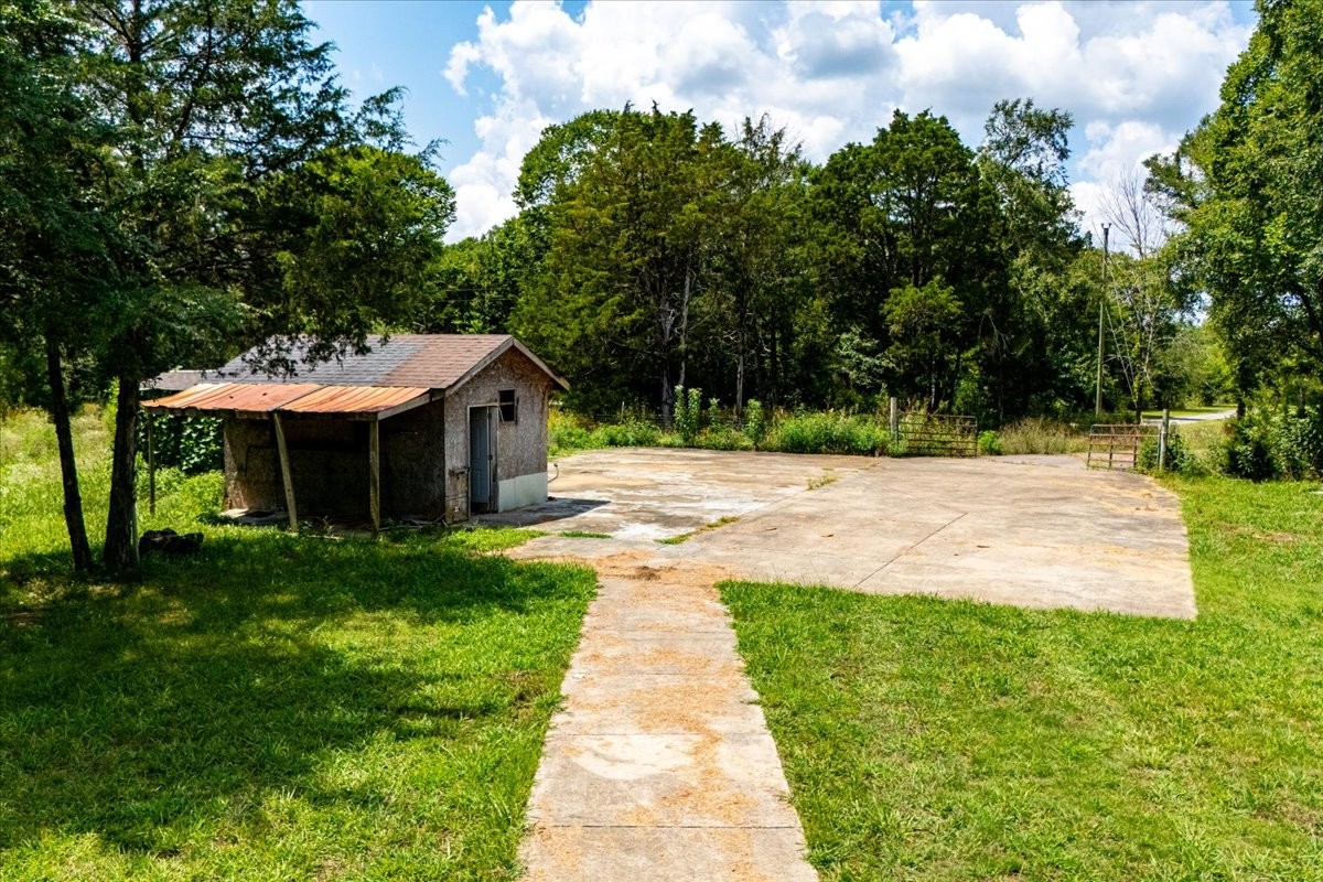 9484 Rocky Hill Road Lascassas, TN 37085 - Photo 32 of 38 a front view of a house with a yard and trees