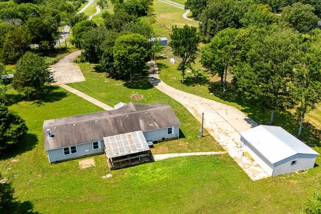 an aerial view of a house with a garden and swimming pool