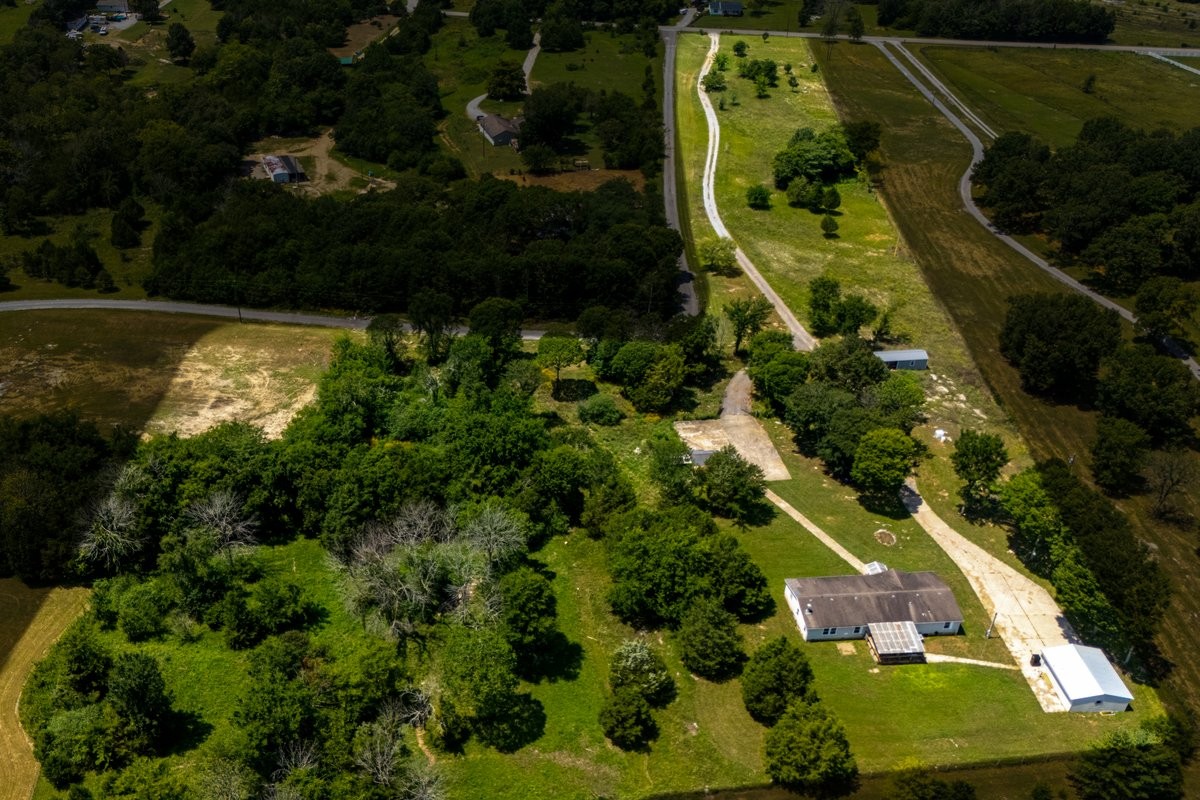 9484 Rocky Hill Road Lascassas, TN 37085 - Photo 38 of 38 an aerial view of residential houses with outdoor space and swimming pool