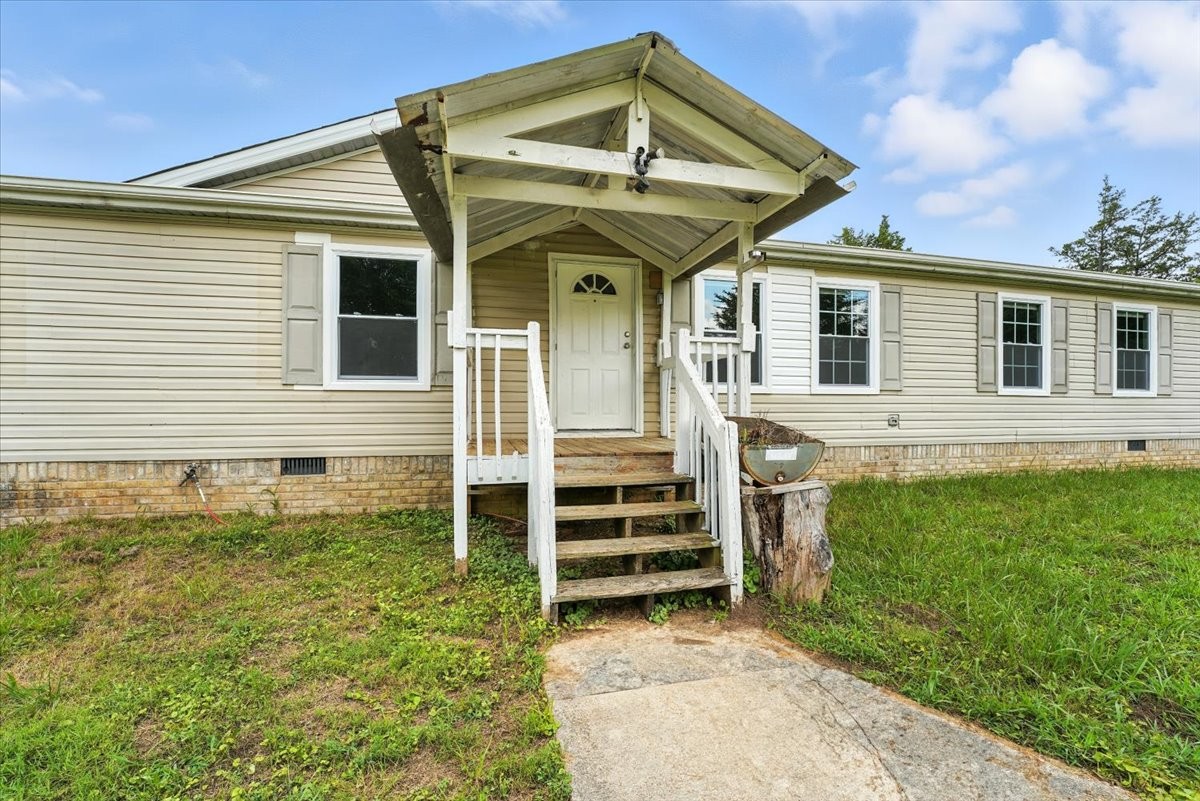 9484 Rocky Hill Road Lascassas, TN 37085 - Photo 4 of 38 a front view of a house with a yard