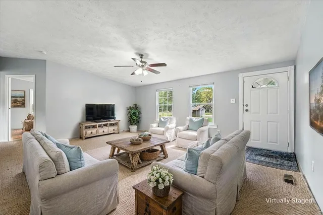 a living room with furniture and a flat screen tv
