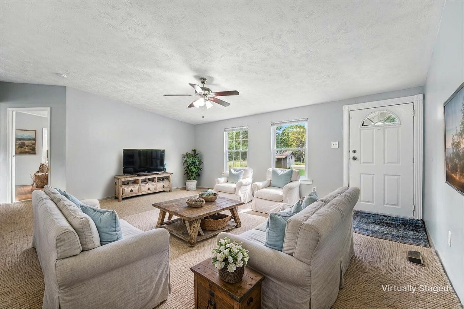 9484 Rocky Hill Road Lascassas, TN 37085 - Photo 7 of 38 a living room with furniture and a flat screen tv