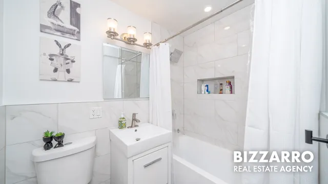a view of a bedroom with wooden floor & bathroom