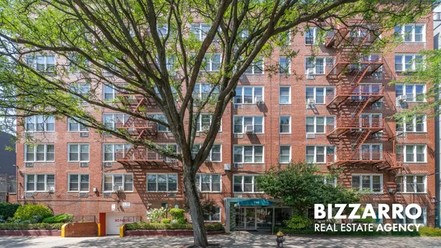 a view of a hallway with furniture and a chandelier