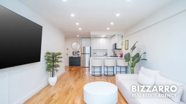 a living room with furniture and a potted plant