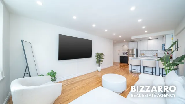 a living room with kitchen island furniture and a wooden floor