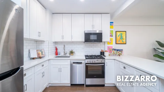 a kitchen with stainless steel appliances granite countertop a refrigerator sink and stove