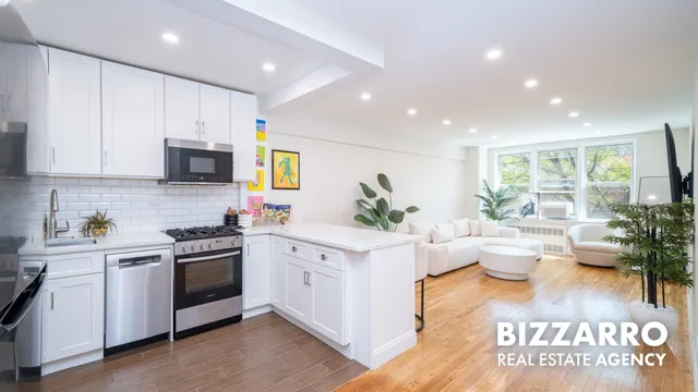 a kitchen with stainless steel appliances a sink a stove and cabinets