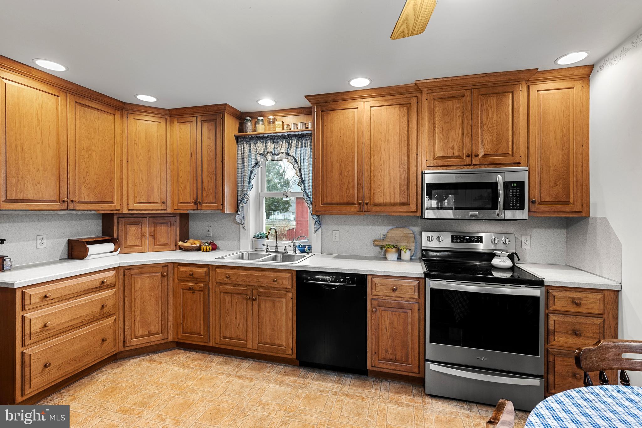 954 Anderson Ferry Road Mount Joy, PA 17552 - Photo 6 of 40 a kitchen with stainless steel appliances granite countertop a stove a sink dishwasher and a microwave
