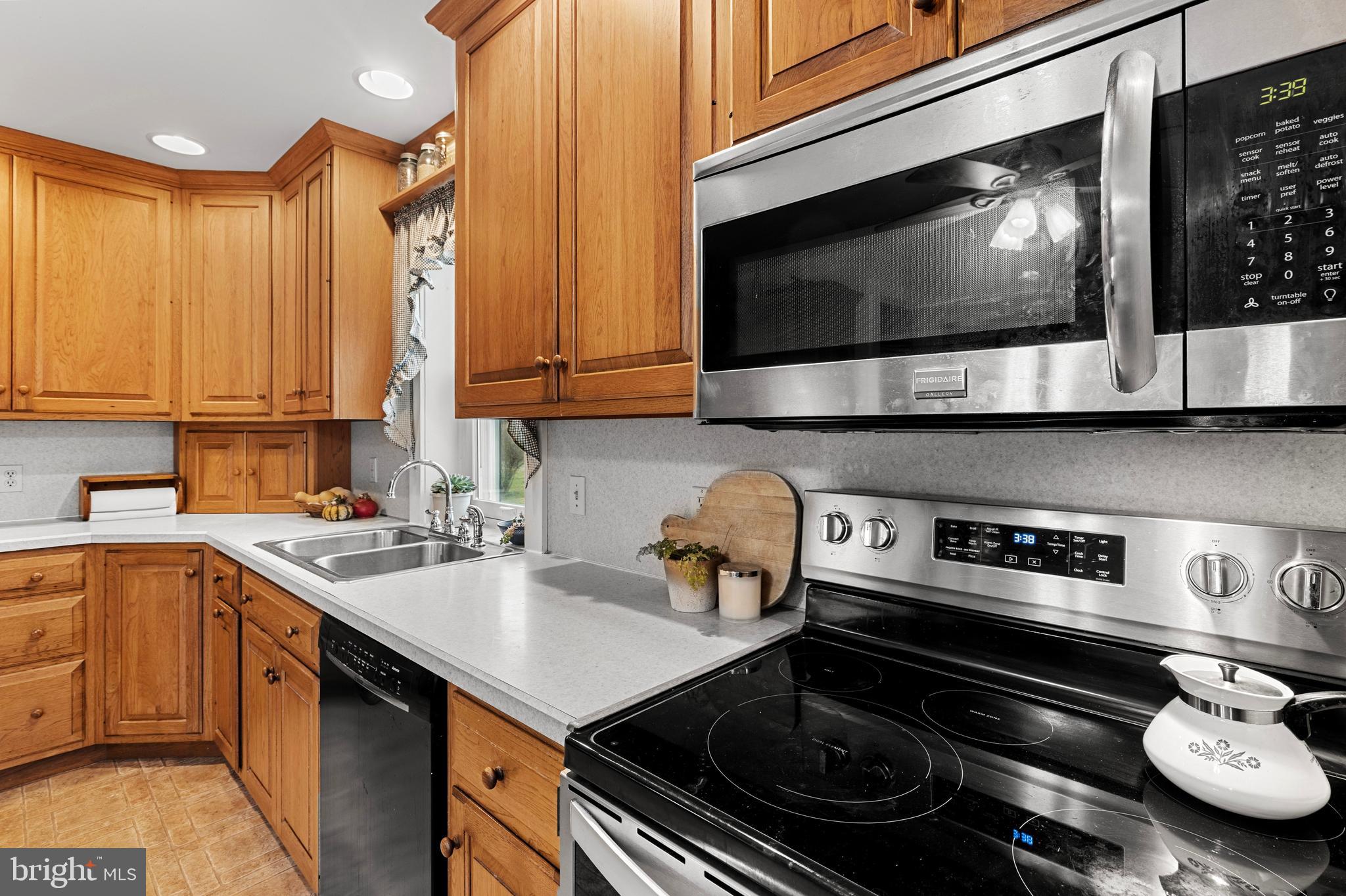 954 Anderson Ferry Road Mount Joy, PA 17552 - Photo 9 of 40 a kitchen with a stove a microwave a sink and cabinets