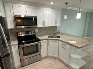Undisclosed Address Fort Lauderdale, FL 33306 - Photo 14 of 26 a kitchen with a stove and a microwave