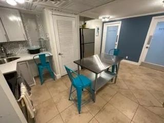 a kitchen with stainless steel appliances granite countertop a sink a stove and a refrigerator