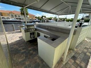 Undisclosed Address Fort Lauderdale, FL 33306 - Photo 19 of 26 a kitchen with stainless steel appliances granite countertop a sink a stove and a refrigerator