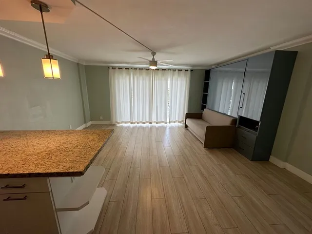 a view of kitchen with furniture and wooden floor