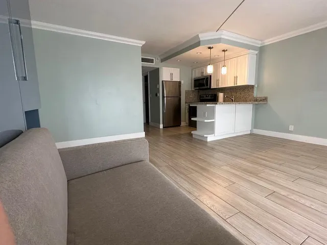 a view of kitchen and wooden floor