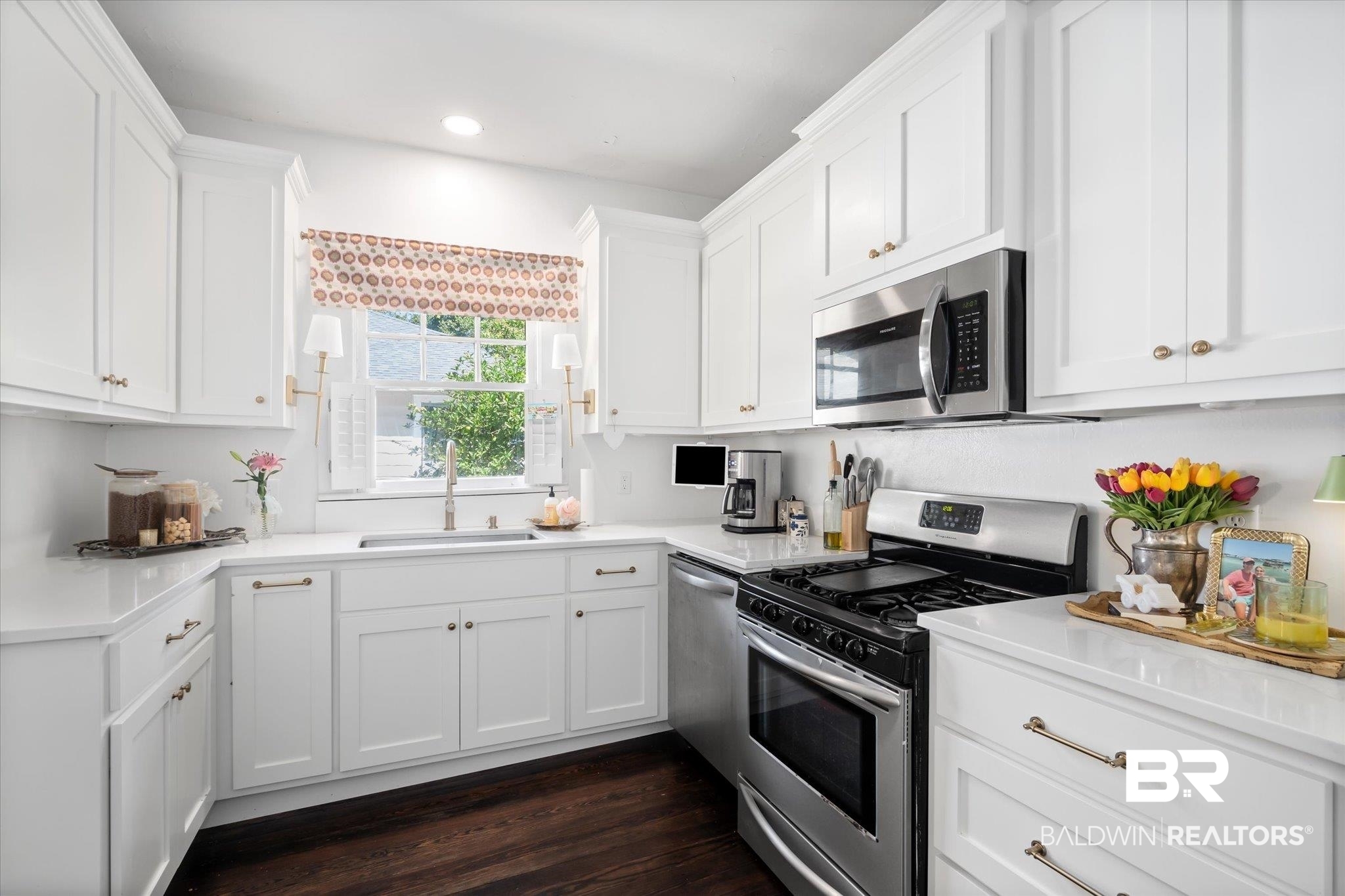 115 Bienville Avenue Mobile, AL 36606 - Photo 6 of 19 Kitchen with white cabinets, appliances with stainless steel finishes, sink, and dark hardwood / wood-style flooring