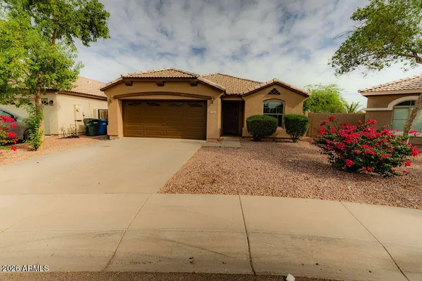 a front view of a house with a yard and a garage