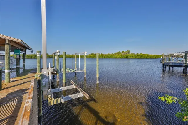 an empty room with wooden floor fireplace and windows