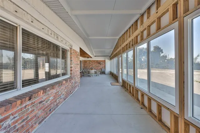 a bedroom with a bed a lamp and a potted plant