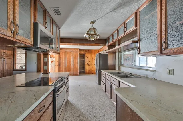 an aerial view of a multi story residential apartment building with a yard