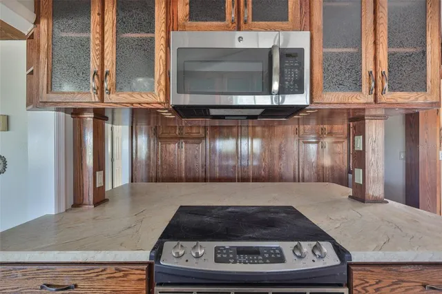 a backyard of a house with barbeque oven table and chairs