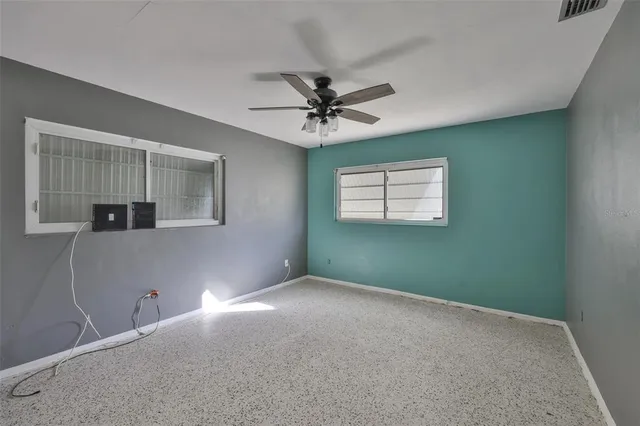 an aerial view of a house with a yard and lake view