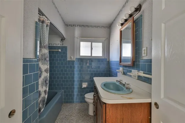 an aerial view of a residential houses with outdoor space and swimming pool