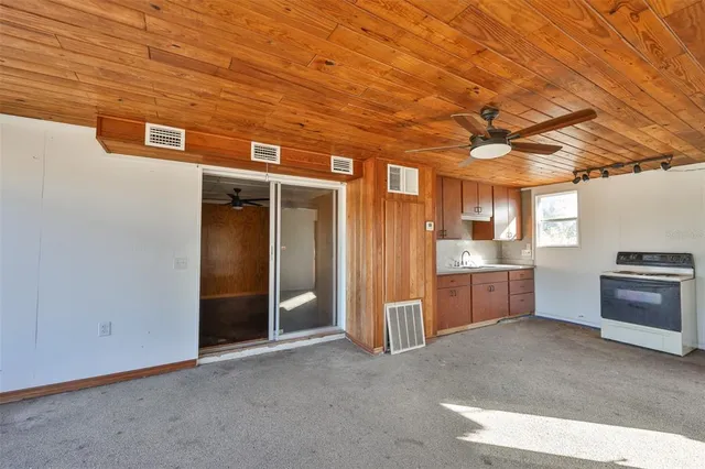 an aerial view of a house with a yard and lake view