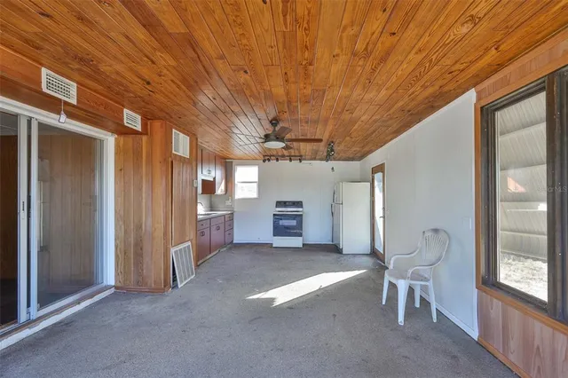 a backyard of a house with lots of green space and lake view