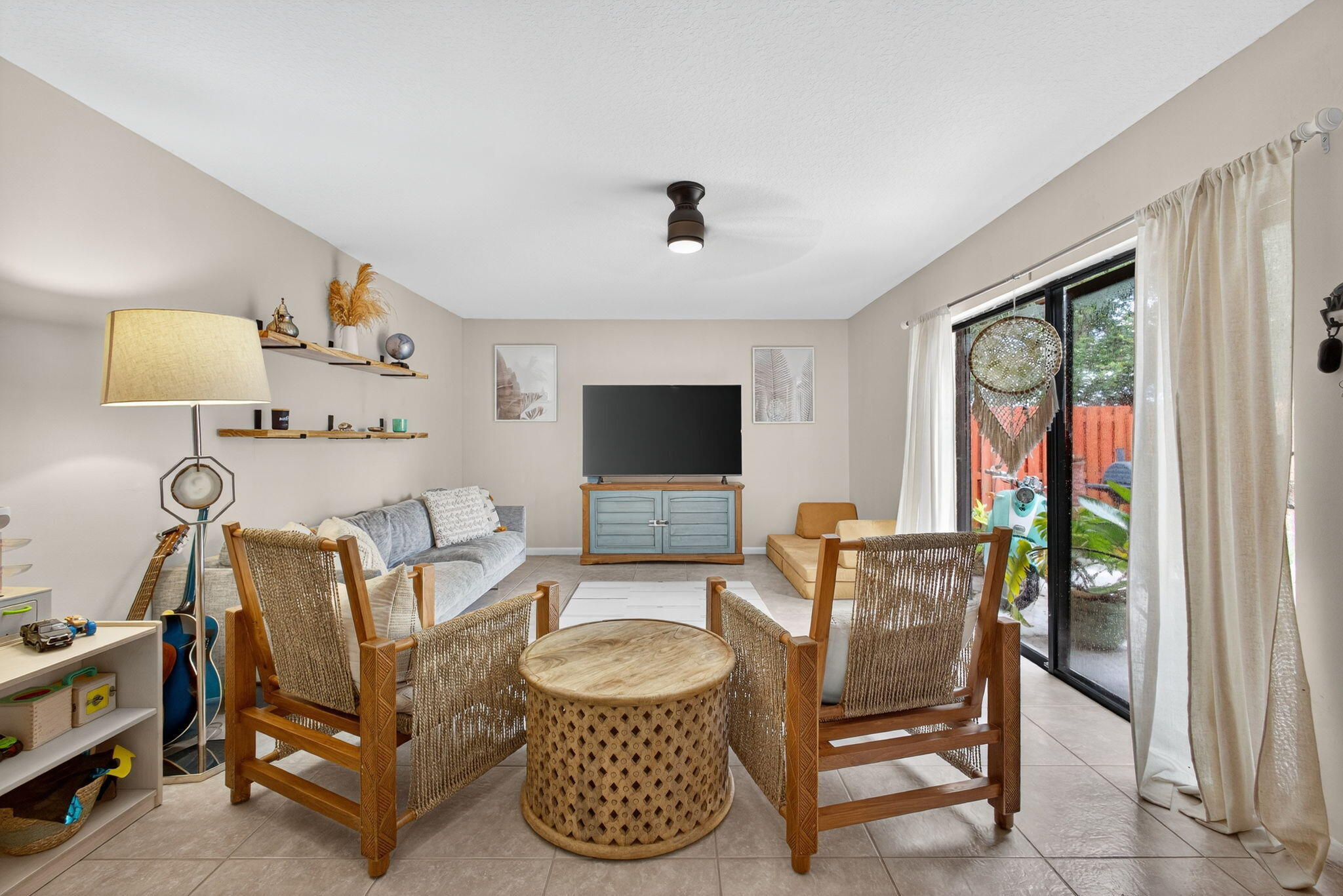 326 Jupiter Lakes Boulevard, Unit 2310C Jupiter, FL 33458 - Photo 15 of 46 a living room with furniture and a flat screen tv