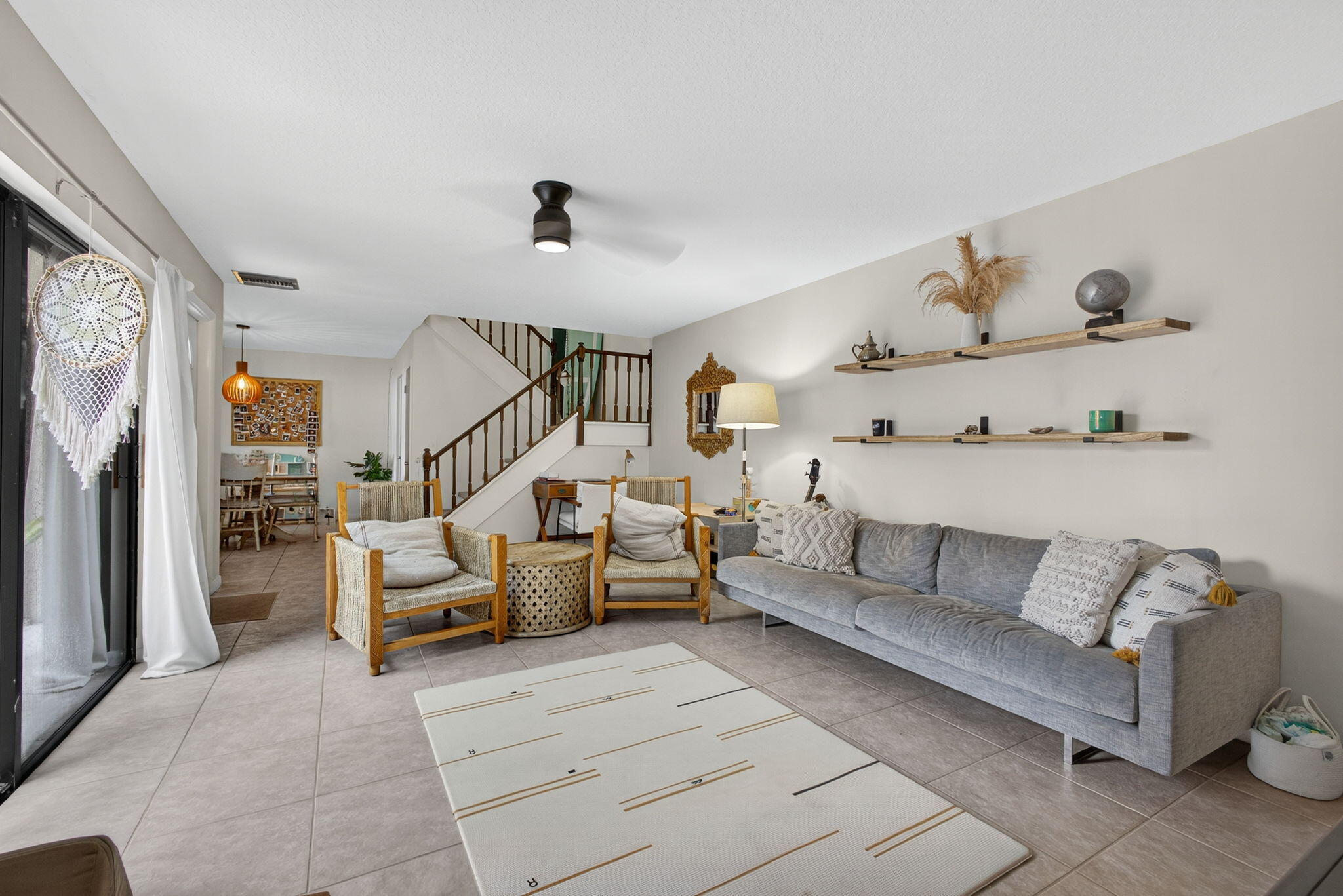 326 Jupiter Lakes Boulevard, Unit 2310C Jupiter, FL 33458 - Photo 16 of 46 a living room with furniture and a flat screen tv