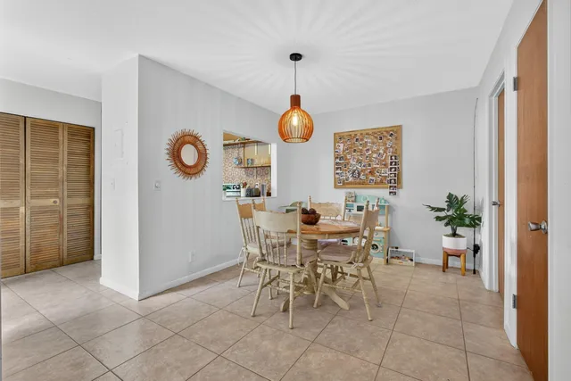 a dining room with furniture and a window