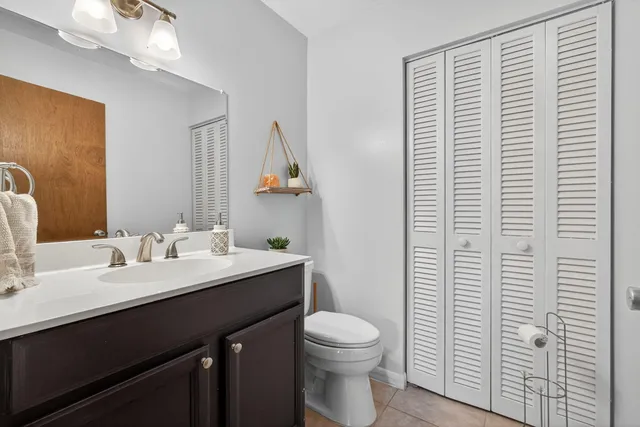 a bathroom with a toilet a sink and mirror