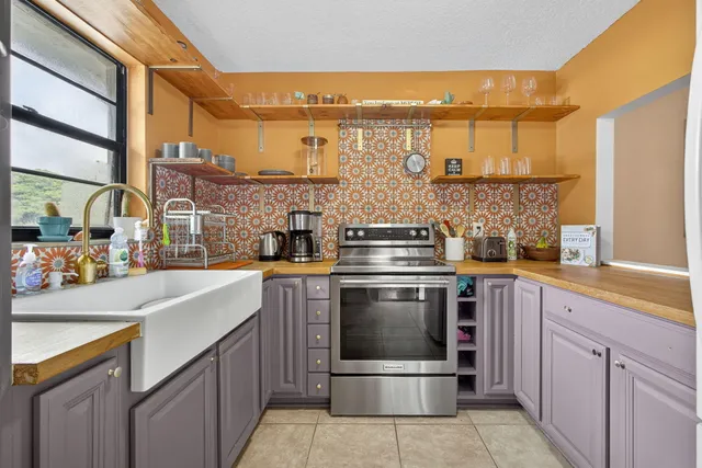 a kitchen with stainless steel appliances a stove and a sink