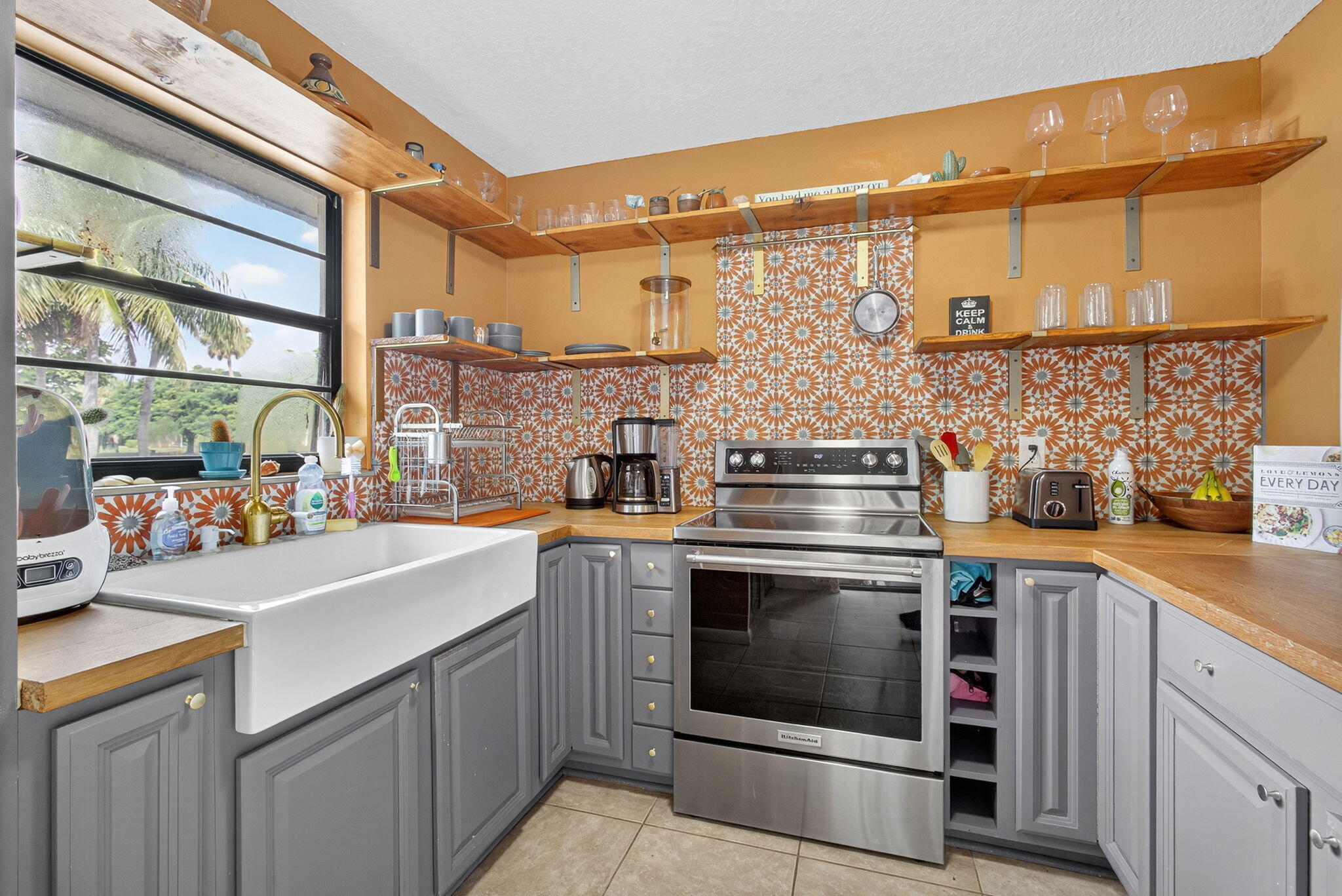326 Jupiter Lakes Boulevard, Unit 2310C Jupiter, FL 33458 - Photo 24 of 46 a kitchen with stainless steel appliances a stove and a sink