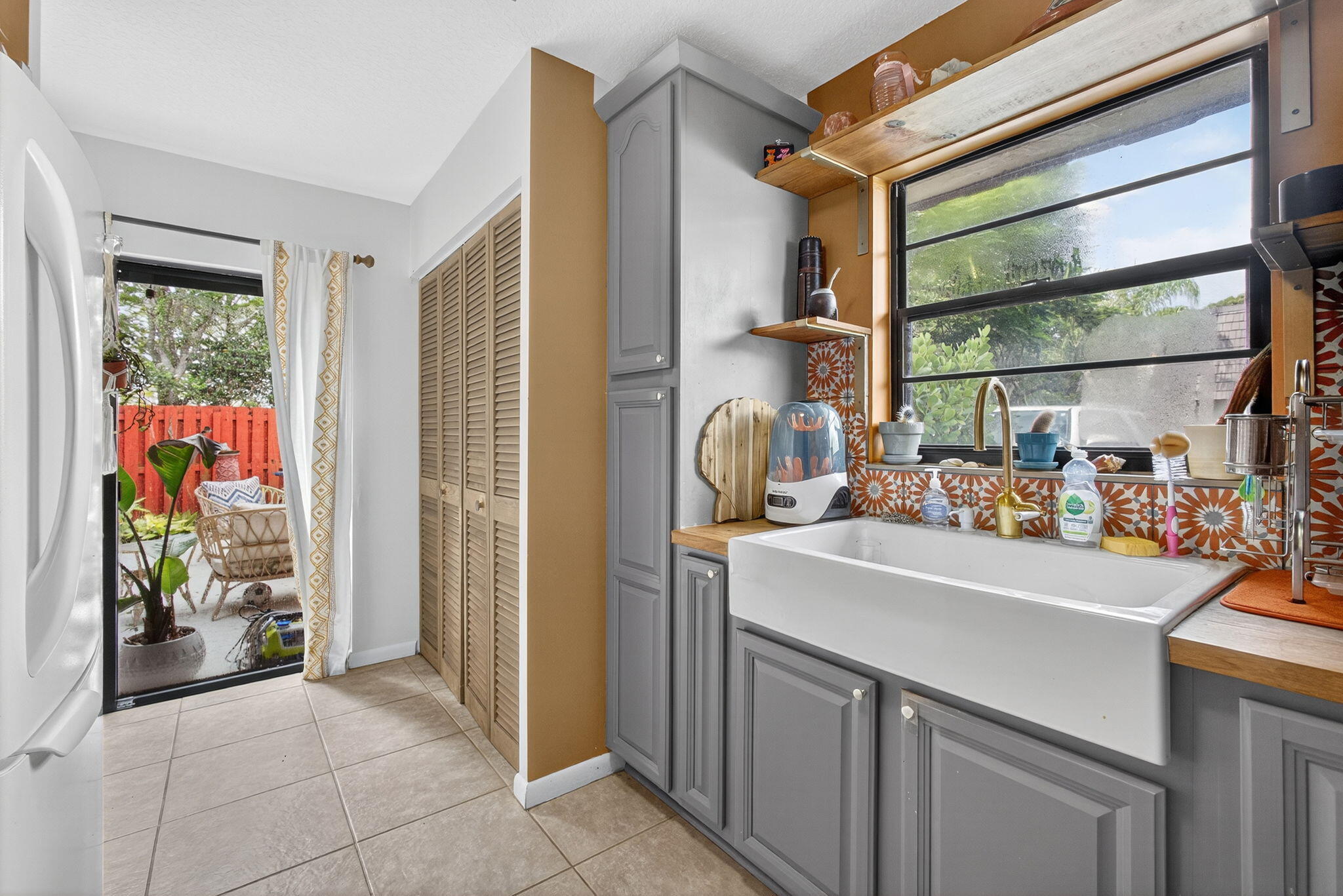 326 Jupiter Lakes Boulevard, Unit 2310C Jupiter, FL 33458 - Photo 26 of 46 a view of a kitchen area with furniture and a window