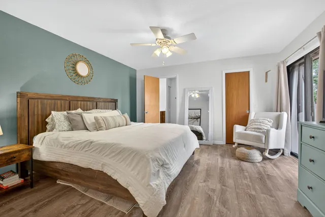 a bedroom with a bed and a chandelier